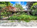 Charming stone home with lush greenery creating a private and picturesque setting at 3317 S 100 E, Greenfield, IN 46140