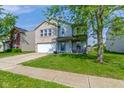 Charming two-story home with a well-maintained front lawn and attached two-car garage at 3362 Pavetto Ln, Indianapolis, IN 46203