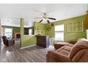 Cozy living room featuring an open layout, wood floors, and modern ceiling fan at 3362 Pavetto Ln, Indianapolis, IN 46203