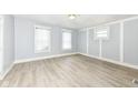 Bright bedroom with light-toned laminate flooring, neutral walls and trim, and natural light from three windows at 352 W 28Th St, Indianapolis, IN 46208