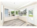 Spacious screened porch with natural light, light-toned plank flooring, and neutral paint at 352 W 28Th St, Indianapolis, IN 46208