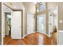 Inviting foyer with hardwood floors and decorative glass front door at 3532 Clearwater Cir, Indianapolis, IN 46240
