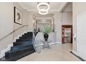 Elegant building lobby featuring modern lighting, stylish staircase, and elevator access at 355 E Ohio St # 209, Indianapolis, IN 46204