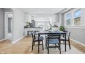 Bright dining room with modern table and chairs, flowing into the kitchen area at 3906 Fletcher Ave, Indianapolis, IN 46203