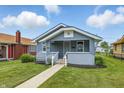 Charming bungalow featuring a cozy front porch, landscaped yard, and well-maintained exterior in a residential neighborhood at 3906 Fletcher Ave, Indianapolis, IN 46203