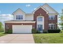 Lovely two-story home with brick and siding, lush green lawn, and a convenient two-car garage at 4017 Ivory Ct, Carmel, IN 46074