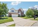 Beautiful two-story home boasting brick and siding, a well-kept lawn, and a spacious driveway at 4017 Ivory Ct, Carmel, IN 46074