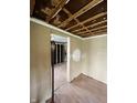 An interior shot shows a partially renovated room with hardwood floors, exposed framing, and natural light at 4206 Clark St, Anderson, IN 46013
