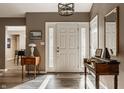 Welcoming home foyer with wood floors, stylish lighting, and classic decor at 4428 Edinburgh Pt, Indianapolis, IN 46228
