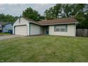 Classic home with white siding, a brown roof, well-maintained lawn, and a two-car garage at 4428 Tucson Dr, Indianapolis, IN 46241