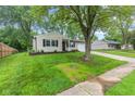 Attractive single-Gathering home with a well-manicured front yard, tidy flower beds, and mature shade trees at 6310 Kellum Dr, Indianapolis, IN 46221