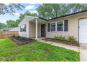 Well-kept home featuring a charming entry way and landscaping with colorful flowerbeds at 6310 Kellum Dr, Indianapolis, IN 46221