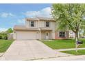 Charming two-story home features a well-manicured lawn, brick accents, and a welcoming front entrance at 6320 River Valley Way, Indianapolis, IN 46221