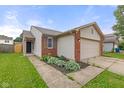 Home with neat landscaping, including greenery in front, and a two car garage at 6332 Long River Ln, Indianapolis, IN 46221