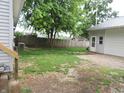 Spacious backyard featuring a detached garage and a wood fence in the background at 6344 Turner Dr, Clayton, IN 46118
