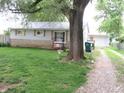 Landscaped side yard showing driveway leading to detached two-car garage at 6344 Turner Dr, Clayton, IN 46118