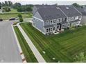 Landscaped backyard featuring a lush lawn, a cozy patio, and a charming sitting area at 640 Axford Bay Dr, Westfield, IN 46074