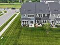 Landscaped backyard featuring a lush lawn, a cozy patio, and a charming sitting area at 640 Axford Bay Dr, Westfield, IN 46074