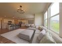 Open floor plan with a spacious living room, dining area, and a cozy sectional sofa at 640 Axford Bay Dr, Westfield, IN 46074