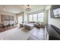 Bright living room with a large sectional sofa, modern lighting, and beautiful hardwood floors at 640 Axford Bay Dr, Westfield, IN 46074