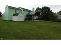 This backyard offers a shed and covered patio perfect for relaxing at 6714 Colleens Way, Indianapolis, IN 46221