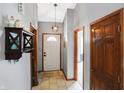 Welcoming foyer with neutral walls, tiled flooring, and decorative light fixture at 6842 Sextant Dr, Indianapolis, IN 46260