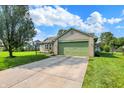 Ranch-style house with a green lawn, brick accents, an attached garage, and blue skies at 6842 Sextant Dr, Indianapolis, IN 46260