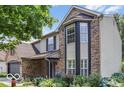 View of home's exterior features brick and vinyl siding plus manicured landscaping at 7211 Topp Creek Ct, Indianapolis, IN 46214
