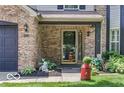 Inviting front entrance with brick surround and charming landscaped details at 7211 Topp Creek Ct, Indianapolis, IN 46214