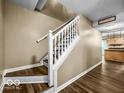 Traditional staircase with wooden treads and white railings at 7211 Topp Creek Ct, Indianapolis, IN 46214