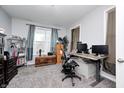 Comfortable office with neutral carpet, gray walls, bright window, and computer desk at 749 Bracknell Dr, Avon, IN 46123
