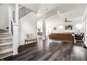 Open-concept living space with dark wood floors, modern furniture, and natural light streaming through windows at 805 N Temple Ave, Indianapolis, IN 46201