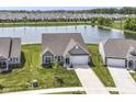Bird's eye view showcases the home's location near a pond and other houses at 8263 Bryce Blvd, Pendleton, IN 46064