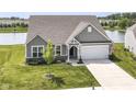 Aerial view of a lovely home with an attached garage in a neighborhood on a pond at 8263 Bryce Blvd, Pendleton, IN 46064