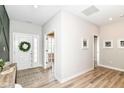 Inviting foyer with wood floors and a white front door decorated with a green wreath at 8263 Bryce Blvd, Pendleton, IN 46064