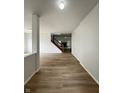 Spacious hallway with hardwood floors leading to a staircase and living areas at 832 Spinney Ln, Whiteland, IN 46184