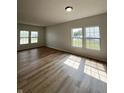 Bright and airy living room featuring hardwood floors and ample natural light from large windows at 832 Spinney Ln, Whiteland, IN 46184