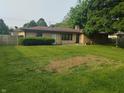 Spacious backyard featuring lush greenery and a privacy fence at 1050 E 106Th St, Carmel, IN 46280