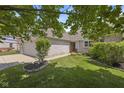 Beautifully landscaped front yard with lush greenery and manicured shrubs surrounding a lovely brick home at 10934 Harness Ct, Indianapolis, IN 46239