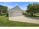 Charming house with a spacious driveway leading to an attached two-car garage, perfect for parking and storage at 10934 Harness Ct, Indianapolis, IN 46239