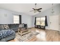 Bright living room with a vaulted ceiling, ceiling fan and comfortable gray seating arrangement at 10973 Freeman Ct, Indianapolis, IN 46234
