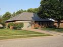 Attractive single-story brick house with a well-kept lawn and attached garage in a quiet neighborhood at 1201 Briarwood Dr, Brownsburg, IN 46112