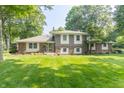 Beautifully landscaped lawn and colorful planters complement this brick and siding two-story home at 12014 Briar Way Center Dr, Indianapolis, IN 46126