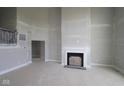 Unfinished living room showcasing a fireplace, neutral paint, and an open-concept design at 12338 French Cattle Way, Noblesville, IN 46060