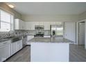 Bright kitchen featuring white cabinets, stainless appliances, and a marble island at 12382 Cool Winds Way, Fishers, IN 46037