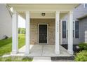 Welcoming front porch adorned with white columns and brickwork, offering a cozy entrance at 12382 Cool Winds Way, Fishers, IN 46037