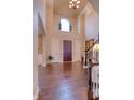 Bright foyer with soaring ceilings, hardwood floors, and elegant chandelier at 13429 Boxelder Ct, Carmel, IN 46074