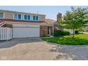 Charming brick townhome featuring an attached garage, manicured lawn, and mature landscaping at 1510 Dominion Dr, Zionsville, IN 46077