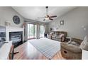 Inviting living room with fireplace, vaulted ceiling, wood floors, and sliding doors at 1630 Eastfork Dr, Brownsburg, IN 46112