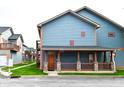 Charming blue two-story home with inviting porch and stone accents. Houses in the distance at 1635 N College Ave # 4, Indianapolis, IN 46202